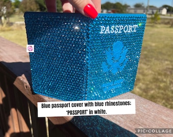 May include: A bright blue passport cover completely encrusted with matching blue rhinestones. The word PASSPORT is spelled out in white rhinestones at the top, and a white rhinestone eagle emblem is centred on the front cover.