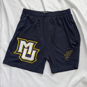 May include: Navy blue mesh shorts featuring a yellow and white logo on the left leg and a smaller yellow logo on the right leg. The shorts have an elasticated waistband and pockets.
