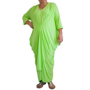 May include: A lime green, long-sleeved, draped dress with a V-neckline.