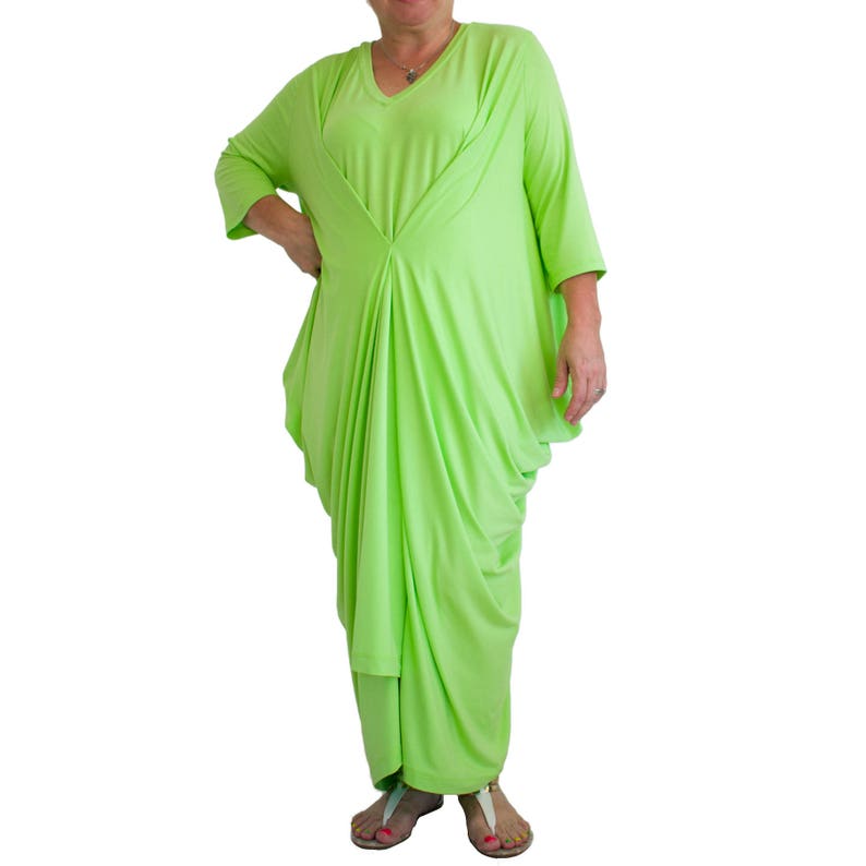 May include: A lime green, long-sleeved, draped dress with a V-neckline.