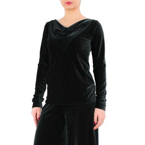 May include: A dark green long-sleeved shirt with a cowl neck. The shirt is made of a soft, velvety material.