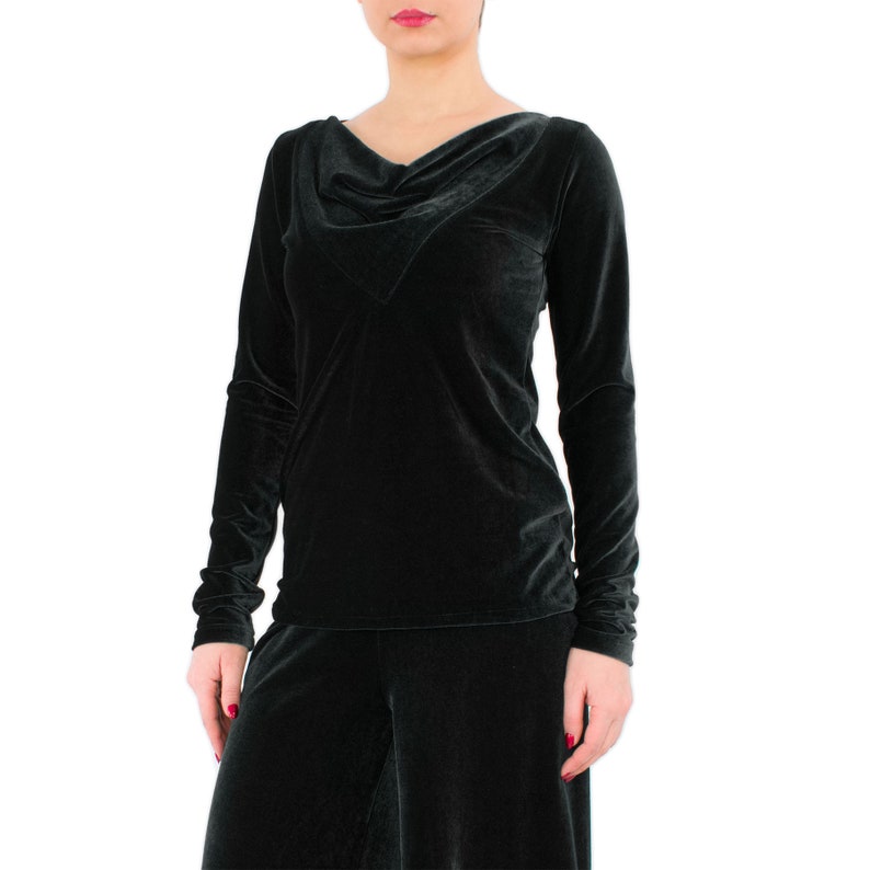 May include: A dark green long-sleeved shirt with a cowl neck. The shirt is made of a soft, velvety material.