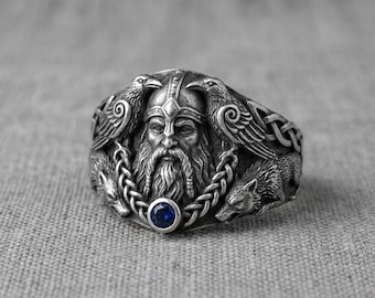 Anillo nórdico de cuervo lobo con piedra azul y nudo celta vikingo.
