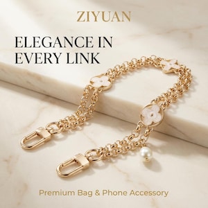 Peut inclure: Bandoulière de sac dorée avec des détails en forme de trèfle et un charme de perle. La bandoulière est dotée de fermoirs mousquetons et du texte "Elegance in Every Link". Un accessoire de sac et de téléphone haut de gamme.