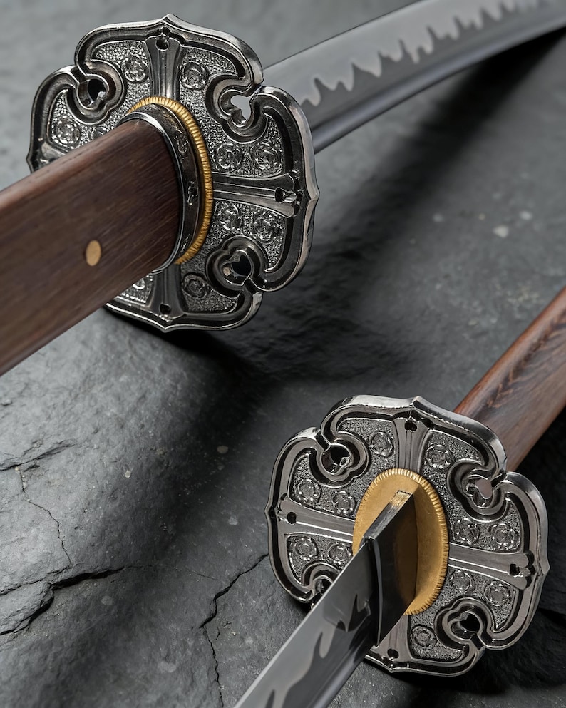 May include: Close-up of two Japanese katana swords. The swords have ornate silver tsubas with floral designs, gold accents, and dark wooden handles. The blades are sharp and reflective, with a visible hamon.