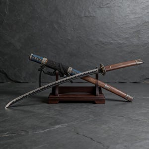 May include: A Japanese katana sword with a curved blade, displayed on a wooden stand. The hilt is wrapped in blue and black fabric, and the scabbard is visible. The sword's blade has a distinctive wavy edge.