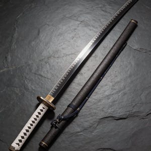 May include: A Japanese katana sword with a curved, silver blade and a white handle wrapped in a diamond pattern. The sword rests beside its black scabbard, which has a blue cord and gold accents. The blade is approximately 71 cm long.