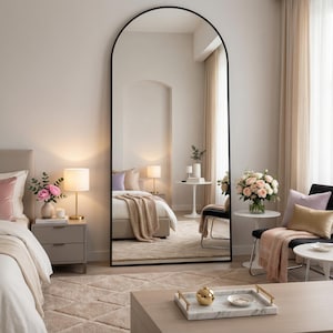 Arched mirror in a soft feminine bedroom with flowers