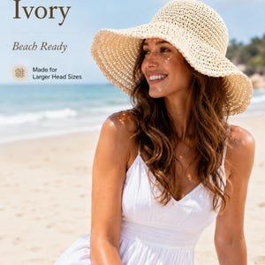 May include: An ivory-colored, wide-brimmed straw hat with a woven texture. The image includes the text Ivory, Beach Ready, and Made for Larger Head Sizes. The hat features a rounded crown and a flexible, downward-sloping brim.