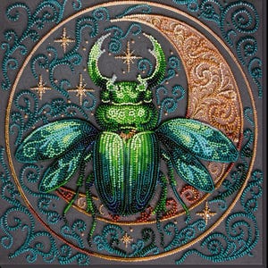 May include: A detailed beaded artwork of a green beetle with iridescent wings, set against a grey background. The beetle is within a gold crescent moon, surrounded by teal swirls and gold stars. The piece has a textured, handcrafted appearance, with a detailed finish.