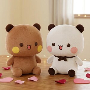 May include: Two plush bear toys, one brown and one white, sit side-by-side on a wooden surface. The brown bear has yellow cheek spots, while the white bear has pink cheek spots and a brown bow tie. Decorative pink and red heart-shaped accents are scattered around.
