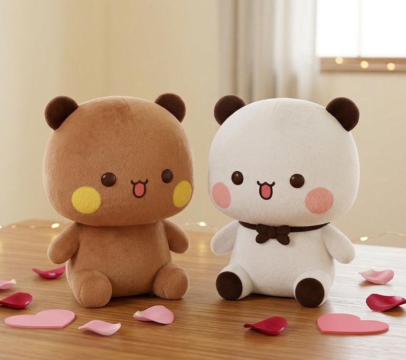 May include: Two plush bear toys, one brown and one white, sit side-by-side on a wooden surface. The brown bear has yellow cheek spots, while the white bear has pink cheek spots and a brown bow tie. Decorative pink and red heart-shaped accents are scattered around.