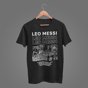 A black t-shirt with a graphic design featuring the text "LEO MESSI" and multiple images of the same person, likely a soccer player.
