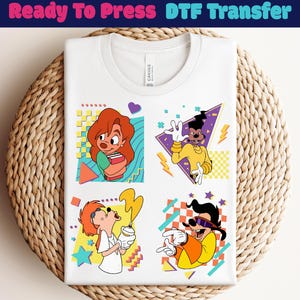 Puede incluir: Camiseta blanca con cuatro diseños de personajes de dibujos animados coloridos. La camiseta tiene el texto "Ready To Press DTF Transfer" en la parte superior. Los diseños incluyen una niña sosteniendo libros, un personaje haciendo un signo de paz, un personaje rociando pintura y un personaje con gafas de sol.