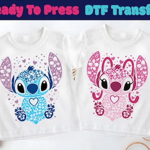May include: Two white t-shirts with a cartoon character design. One shirt features a blue and purple character, and the other has a pink and red character. The text "Ready To Press DTF Transfer" is at the top.
