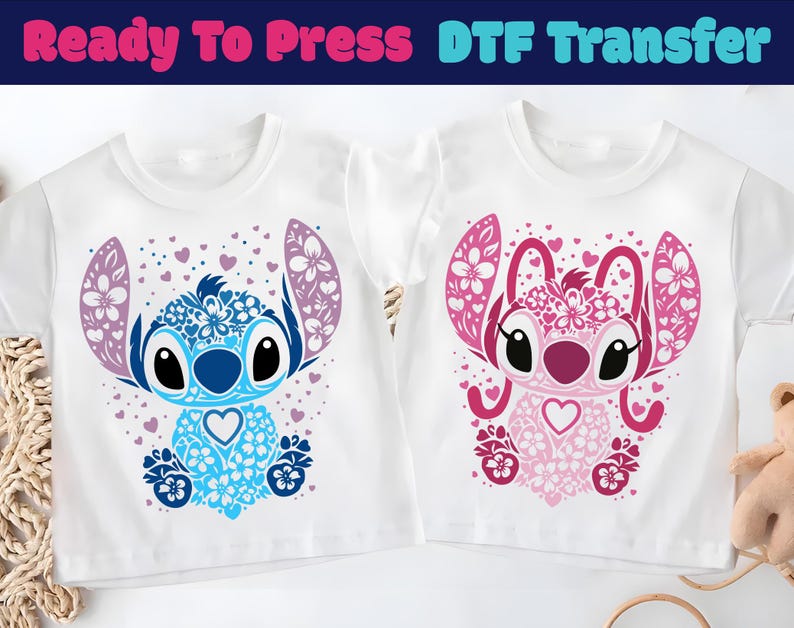 May include: Two white t-shirts with a cartoon character design. One shirt features a blue and purple character, and the other has a pink and red character. The text "Ready To Press DTF Transfer" is at the top.