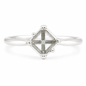 May include: A silver-toned metal ring featuring a square-shaped setting designed to hold a gemstone. The setting is supported by four small prongs at each corner and is attached to a smooth, polished band that tapers slightly toward the center.