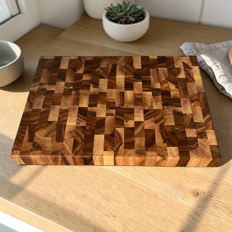 Handmade walnut end grain cutting board on kitchen table, thick butcher block chopping board made from natural walnut wood, premium wooden cutting board for kitchen, durable chef board for cutting meat, vegetables and food preparation
