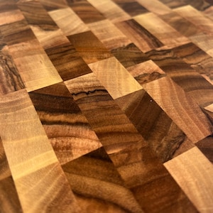 Handmade walnut end grain cutting board on kitchen table, thick butcher block chopping board made from natural walnut wood, premium wooden cutting board for kitchen, durable chef board for cutting meat, vegetables and food preparation