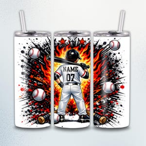 May include: White tumbler with a baseball theme. The design features a baseball player holding a bat, with the text "NAME 07" on the back of the jersey. Baseball bats, baseballs, and a fiery background complete the design. Includes a silver lid and a straw.