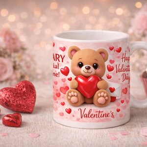 Cute Valentine’s Day coffee mug featuring an adorable teddy bear holding a red heart, surrounded by pink and red hearts. Mug text includes ‘You are BEARY special to me!’ and ‘Happy Valentine’s Day,’ with ‘Valentine’s’ printed at the bottom. Styled on a cozy surface with heart décor, roses, and a cupcake in the background.