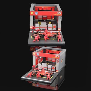 Puede incluir: Diorama en miniatura de un garaje de carreras de F&oacute;rmula 1 con un coche de carreras rojo y su equipo. El garaje tiene detalles en rojo y gris, con el n&uacute;mero "55" y el nombre "CARLOS SAINZ" mostrados. Los logotipos de HP y Ferrari tambi&eacute;n son visibles.