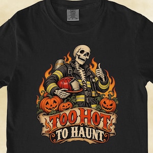 May include: A black short-sleeve t-shirt featuring a graphic of a skeleton dressed as a firefighter, surrounded by flames and jack-o'-lanterns. Below the illustration, a banner displays the text "TOO HOT TO HAUNT" in bold orange letters.