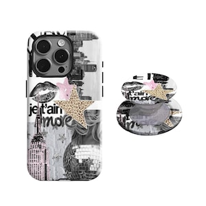 May include: A white and black phone case and matching phone grip featuring a collage design. The case has a cityscape, lips, stars, and the text "je t'aime more". The phone grip has a leopard print star.