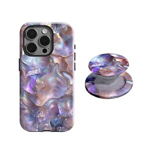 May include: A phone case and matching phone grip featuring a pearlescent design in shades of purple, pink, and gold. The phone case has a black camera module and side buttons. The phone grip is round and has a clear base.