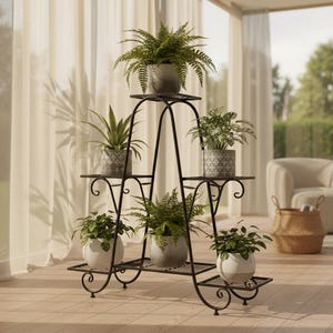 May include: A black metal plant stand with multiple shelves, holding various potted plants. The stand has a decorative, scrolled design and is placed in a bright, airy room with sheer curtains.