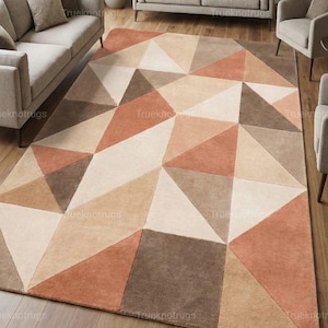 May include: Geometric patterned area rug in shades of beige, brown, and rust. The rug features a repeating pattern of triangles, creating a modern and stylish design. The rug is placed in a living room setting with neutral-toned furniture.