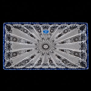 May include: A rectangular clear crystal serving tray featuring an intricate radial starburst pattern with deep geometric cuts. The tray is housed in a blue box and includes a small blue sticker with the text BOHEMIA JIH.