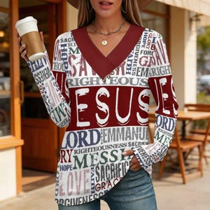 May include: A long-sleeve V-neck shirt featuring a maroon collar and a repeating graphic print of religious words including Jesus, Lord, Messiah, and Righteousness in white, maroon, and dark blue text against a white background.