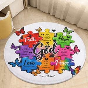 May include: A round white rug featuring a colorful puzzle piece design with the word God in the center. The puzzle pieces contain the words Faith, Hope, Love, and Peace, along with various Bible verses and several vibrant butterflies.