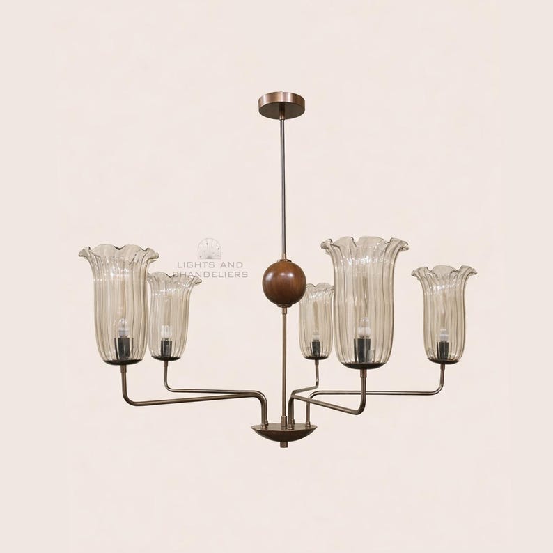 May include: A vintage-style chandelier with six light fixtures. The chandelier features clear, ribbed glass shades shaped like flowers, suspended from a bronze-colored metal frame. A wooden sphere and a central rod support the lights. The text "LIGHTS AND CHANDELIERS" is visible.