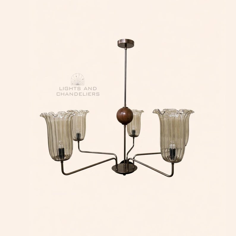 May include: A vintage chandelier with five glass shades. The shades are shaped like flowers and have a ribbed texture. The metal frame is dark, and the fixture hangs from a central rod. The text "LIGHTS AND CHANDELIERS" is in the image.
