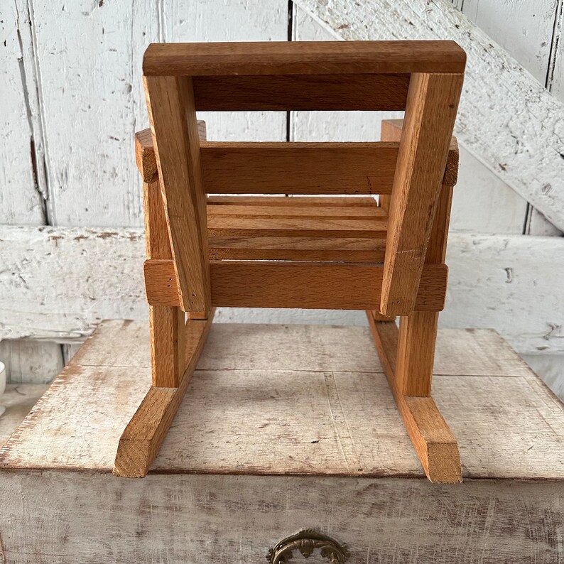 Peut inclure: Petite chaise &agrave; bascule en bois naturel. Le si&egrave;ge et le dossier sont &agrave; lattes, les patins sont incurv&eacute;s. Fabriqu&eacute;e en bois brun clair, elle est con&ccedil;ue pour un enfant.