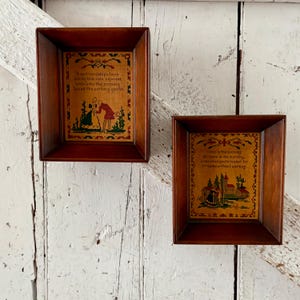 May include: Two framed needlepoint samplers with dark wood frames. One sampler features a couple and the text "True friendships laws are by this rule exprest..." The other sampler has a building and the text "Come in the evening or come in the morning..."