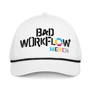 May include: White baseball cap featuring the text "BAD WORKFLOW MERCH" in black, blue, yellow, and pink. The cap has a black rope detail around the brim.