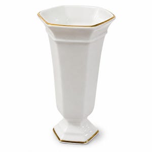 May include: A white porcelain vase featuring a hexagonal shape with a flared rim and a pedestal base. The top edge of the rim and the bottom edge of the base are both accented with a thin, metallic gold trim, providing a refined finish to the piece.