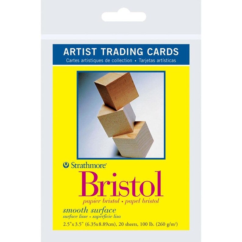 May include: A pack of Strathmore Bristol Artist Trading Cards with a smooth surface. The pack features a yellow background with a stack of wooden blocks. The text on the pack reads "Bristol, papier bristol, papel bristol, smooth surface, surface lisse, superficie lisa, 2.5"x3.5" (6.35x8.89cm), 20 sheets, 100 lb. (260 g/m&sup2;)."