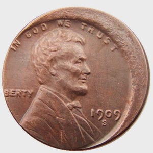 May include: A copper-colored 1909 S Lincoln cent coin. The obverse features a profile of Abraham Lincoln, with the inscriptions "IN GOD WE TRUST" and "LIBERTY". The year "1909" and the mint mark "S" are also visible.