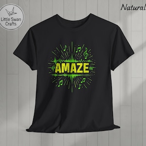 May include: Black t-shirt with a neon green graphic featuring the word "AMAZE" in a stylized font, surrounded by musical notes and sound wave elements. The design is centered on the shirt, creating a bold visual statement.