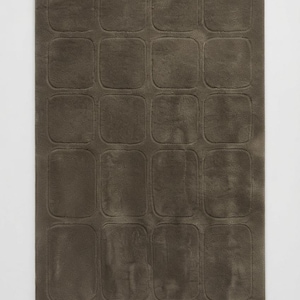 May include: A rectangular area rug in a solid dark taupe color. The surface features a repeating grid pattern of embossed rounded squares and rectangles, creating a subtle texture across the entire piece. The rug has a soft, uniform appearance.
