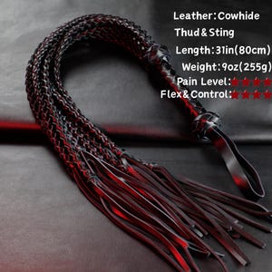 May include: A black cowhide leather whip with a braided handle and multiple leather strands at the end. The whip is 31 inches (78.7 cm) long and weighs 9 ounces (255 grams). The text on the image says "Thud & Sting".
