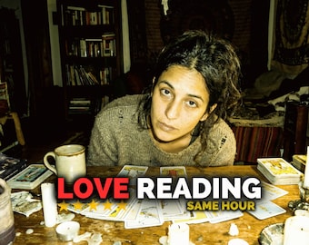 May include: A woman is seated at a wooden table with tarot cards, candles, and a mug. The text "LOVE READING SAME HOUR" is displayed in red and white. The scene is dimly lit, suggesting a mystical or spiritual theme.