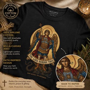 May include: Black t-shirt with a detailed graphic of Saint Michael the Archangel, holding a cross and spear, and the text "THE LORD REBUKE THEE." The shirt also features the text "100% Airlume Cotton" and "Bella+Canvas 3001."