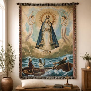 May include: A rectangular woven tapestry featuring a religious scene with a central figure in a blue robe holding a child, flanked by two angels. Below, three people are in a small wooden boat on turbulent ocean waves. The text Ave Maris Stella is visible.
