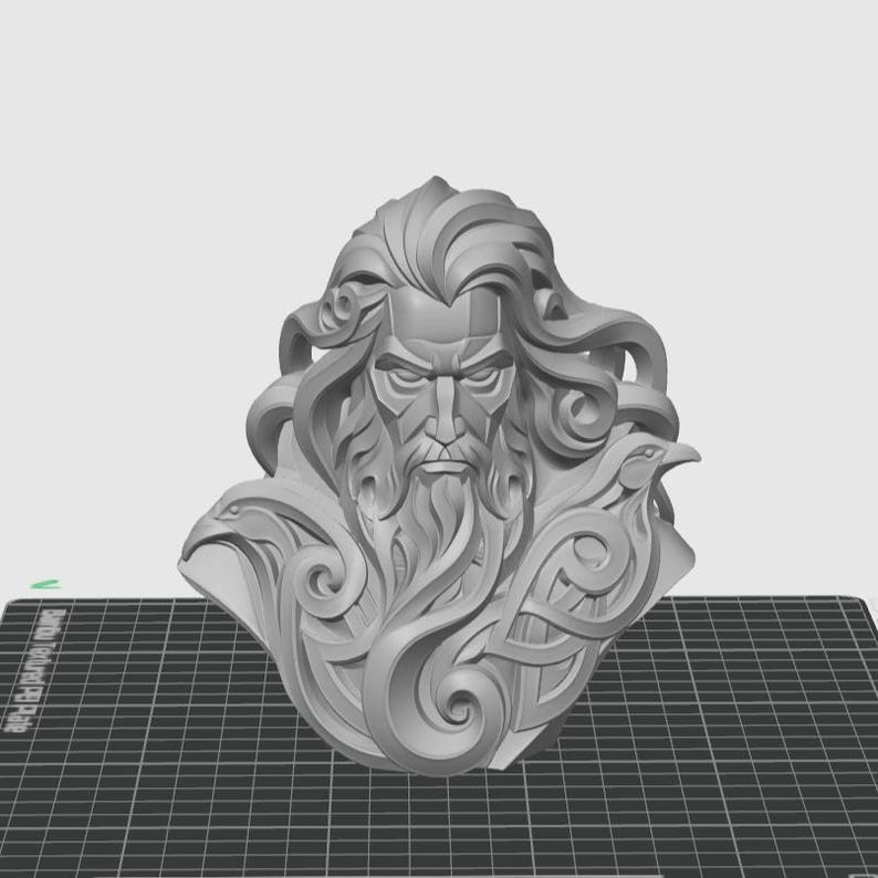 May include: A monochromatic gray 3D printed bust of a bearded figure with long flowing hair, featuring stylized avian motifs integrated into the design on both sides of the face, presented with a smooth finish and intricate sculpted details.