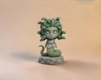 May include: A stylized figurine of a character with a snake-like lower body and a head of snakes, featuring pale green skin, white eyes, and a draped garment. The figure stands on a rocky base, with the text VOID OISION SEE WHAT ISN'T THERE.